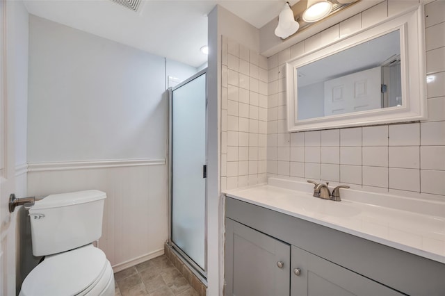 bathroom with toilet, a stall shower, tasteful backsplash, and vanity