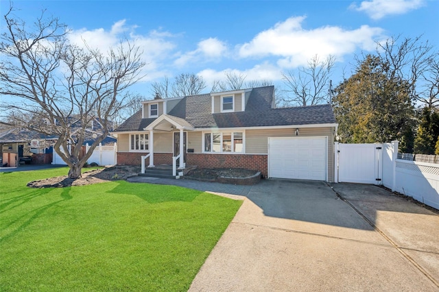 view of front of house with brick siding, concrete driveway, a front yard, a gate, and fence