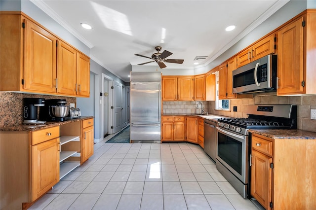 kitchen featuring crown molding, visible vents, appliances with stainless steel finishes, light tile patterned flooring, and a sink