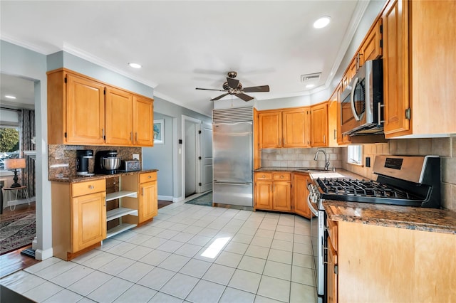 kitchen featuring light tile patterned flooring, a sink, visible vents, ornamental molding, and appliances with stainless steel finishes