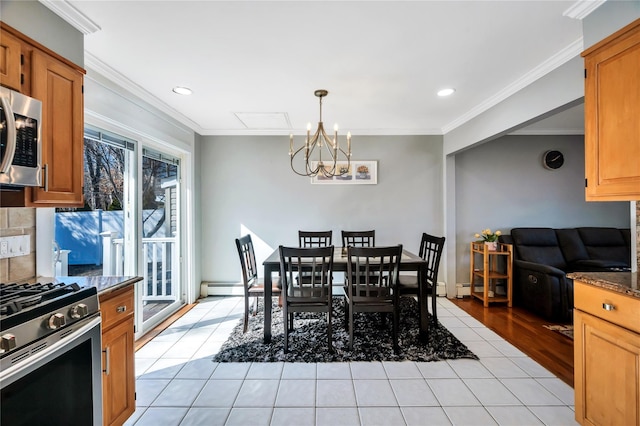 dining space with light tile patterned floors, a notable chandelier, baseboard heating, and crown molding