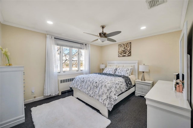 bedroom with baseboards, visible vents, radiator heating unit, dark colored carpet, and crown molding