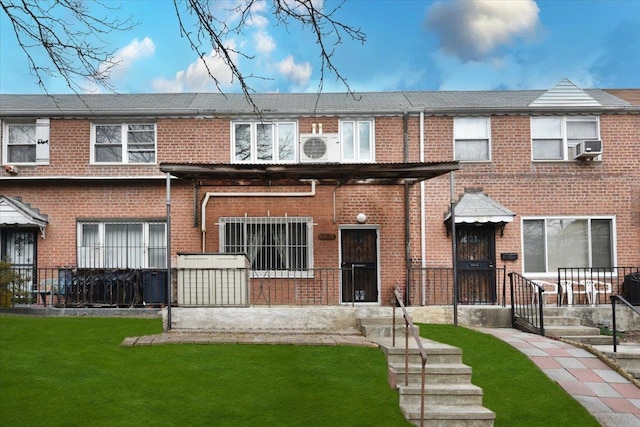 view of front facade featuring a front yard and brick siding