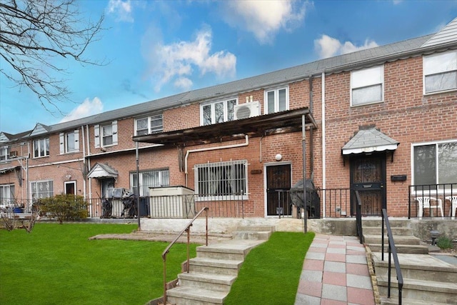 exterior space with brick siding and a front yard