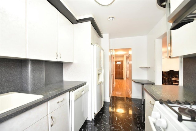 kitchen with white appliances, a sink, decorative backsplash, white cabinetry, and marble finish floor