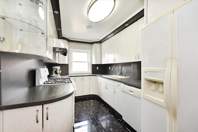 kitchen featuring white appliances, a sink, marble finish floor, white cabinetry, and tasteful backsplash