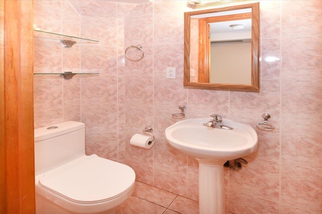 half bath featuring toilet and tile walls