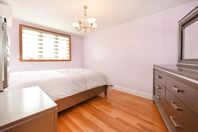 bedroom featuring an inviting chandelier, light wood-style floors, baseboards, and ornamental molding