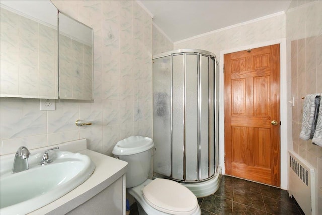 bathroom with crown molding, radiator, tile walls, and a shower stall