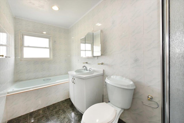 full bath with vanity, tiled tub, ornamental molding, tile walls, and toilet