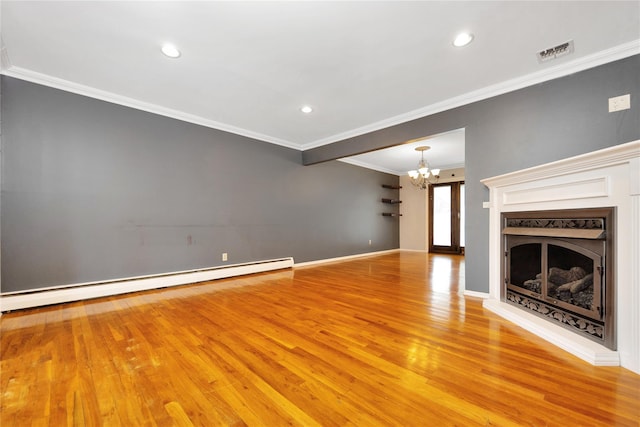 unfurnished living room with a chandelier, a premium fireplace, visible vents, ornamental molding, and baseboard heating