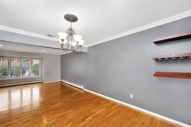 empty room featuring visible vents, a baseboard heating unit, wood finished floors, and ornamental molding