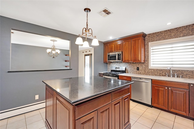 kitchen featuring visible vents, decorative backsplash, a baseboard radiator, appliances with stainless steel finishes, and light tile patterned flooring