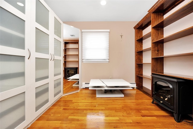 walk in closet featuring visible vents, light wood-type flooring, and a wood stove