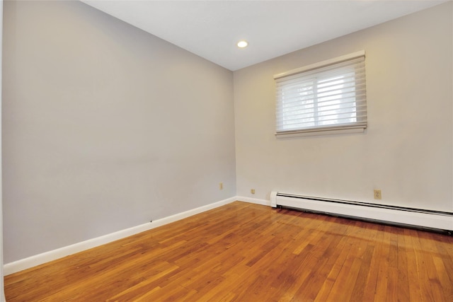 unfurnished room featuring wood-type flooring, baseboards, baseboard heating, and recessed lighting