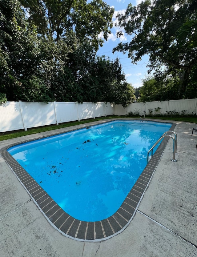 view of swimming pool with a fenced backyard and a fenced in pool