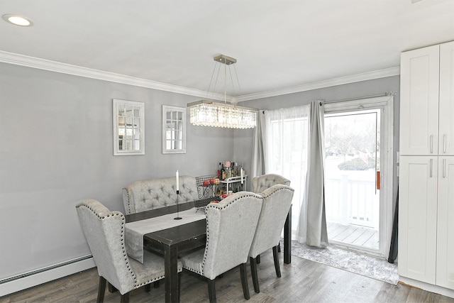 dining space featuring a baseboard heating unit, ornamental molding, and wood finished floors