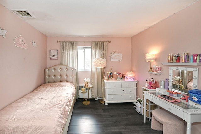 bedroom featuring radiator, visible vents, and dark wood-style flooring