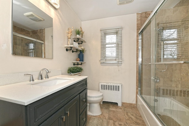 bathroom featuring shower / bath combination with glass door, visible vents, toilet, radiator heating unit, and vanity