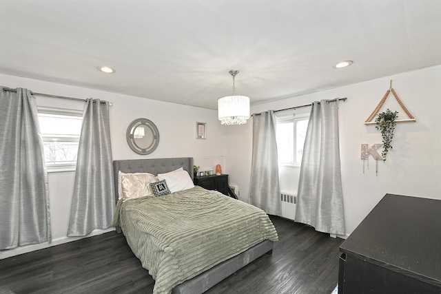 bedroom with radiator, dark wood-type flooring, and recessed lighting