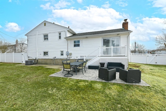 back of house with a gate, a patio area, outdoor lounge area, and a fenced backyard