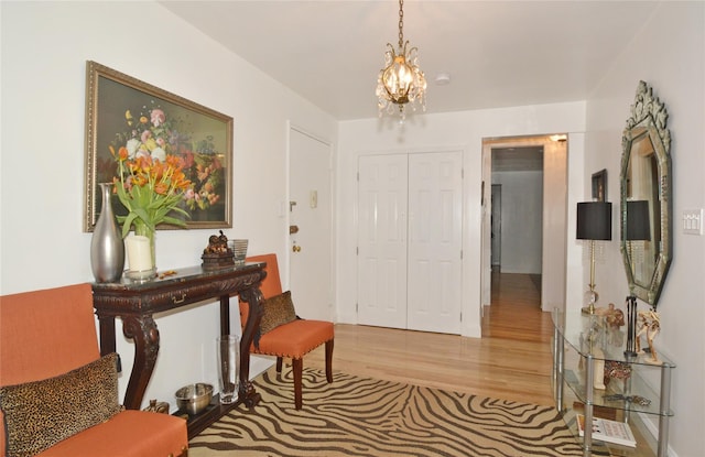 foyer featuring a chandelier and wood finished floors