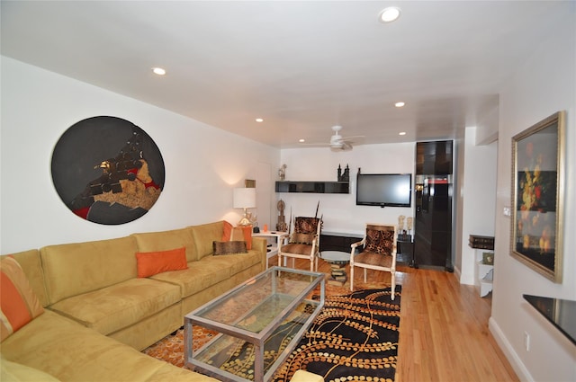 living area featuring baseboards, wood finished floors, a ceiling fan, and recessed lighting