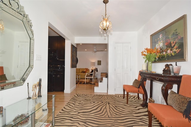 entryway with a chandelier and light wood-style floors