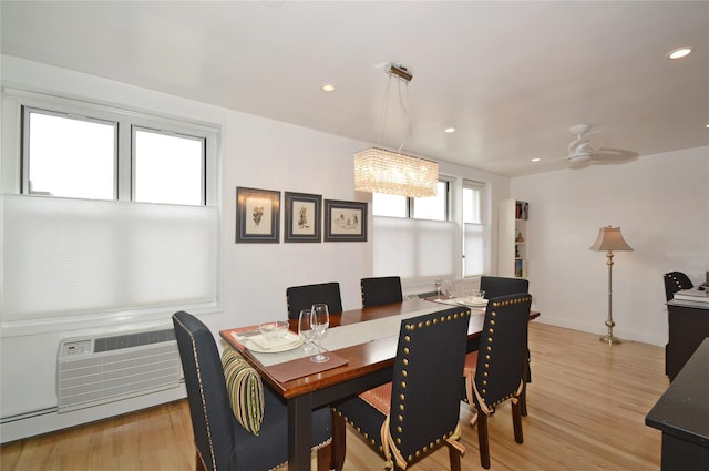 dining area featuring a baseboard heating unit, light wood-style flooring, baseboards, and recessed lighting