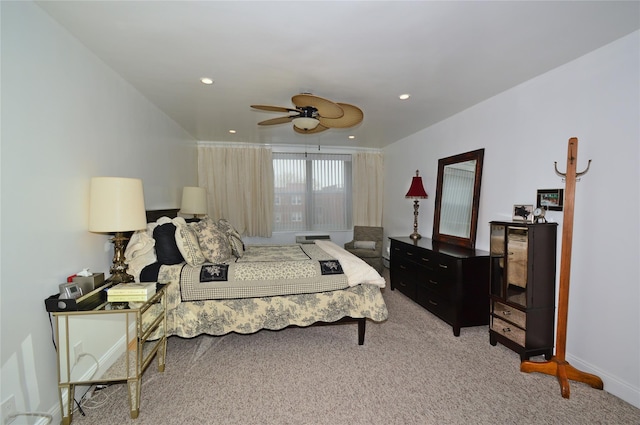 bedroom with ceiling fan, recessed lighting, baseboards, and light colored carpet