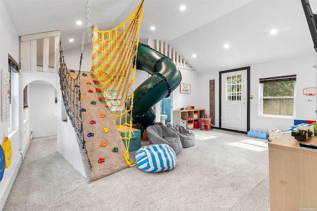 rec room featuring carpet, arched walkways, vaulted ceiling, and recessed lighting