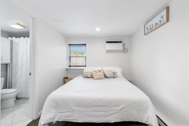 tiled bedroom featuring recessed lighting, an AC wall unit, baseboard heating, and ensuite bathroom