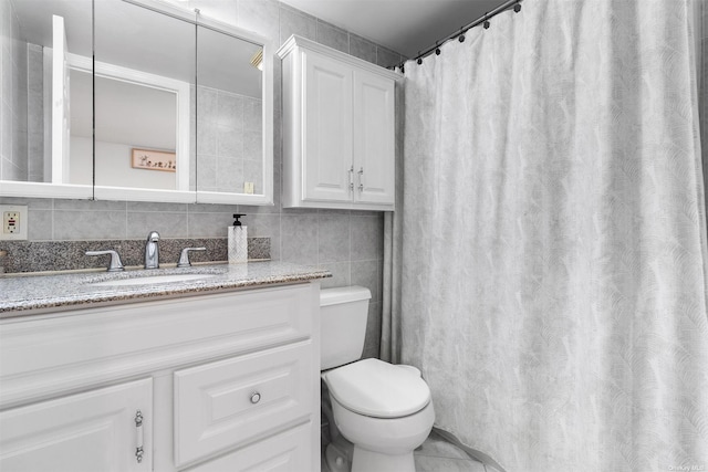 full bathroom featuring toilet, backsplash, tile walls, and vanity