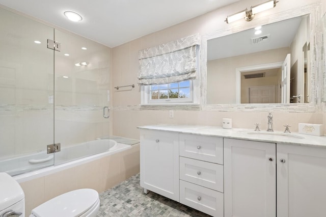 full bath featuring enclosed tub / shower combo, visible vents, vanity, and toilet