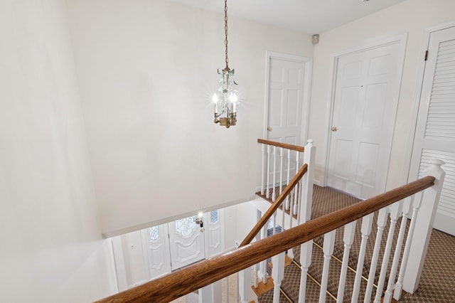 stairway with an inviting chandelier