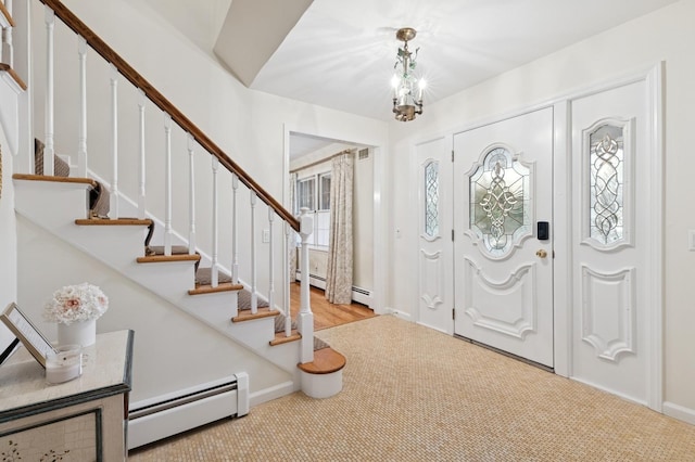 foyer entrance with carpet, a notable chandelier, stairway, and baseboard heating