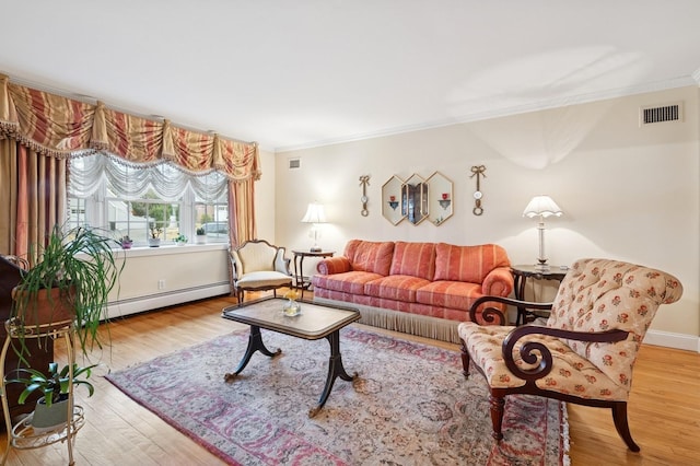 living room with a baseboard radiator, visible vents, wood finished floors, and ornamental molding