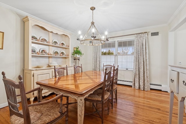 dining area featuring ornamental molding, light wood finished floors, visible vents, and a notable chandelier