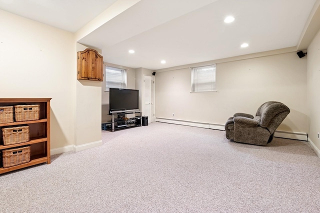 sitting room featuring plenty of natural light, baseboards, a baseboard heating unit, and carpet flooring