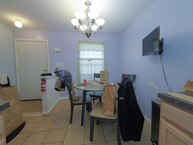 dining room featuring a chandelier, baseboards, and light tile patterned floors