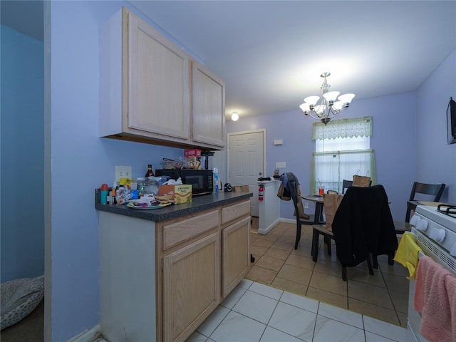 kitchen with dark countertops, light tile patterned flooring, a chandelier, black microwave, and baseboards