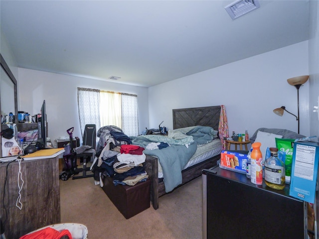 bedroom featuring light carpet and visible vents