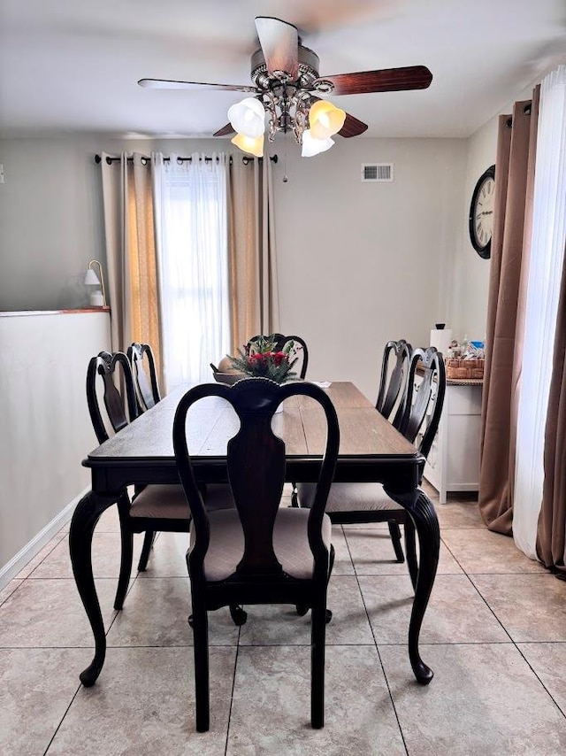 dining space featuring visible vents and light tile patterned flooring