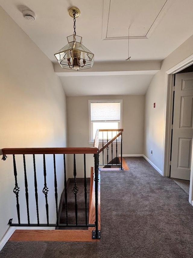 stairs with attic access, baseboards, vaulted ceiling, and carpet flooring