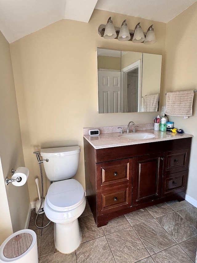 half bath featuring toilet, baseboards, lofted ceiling, and vanity