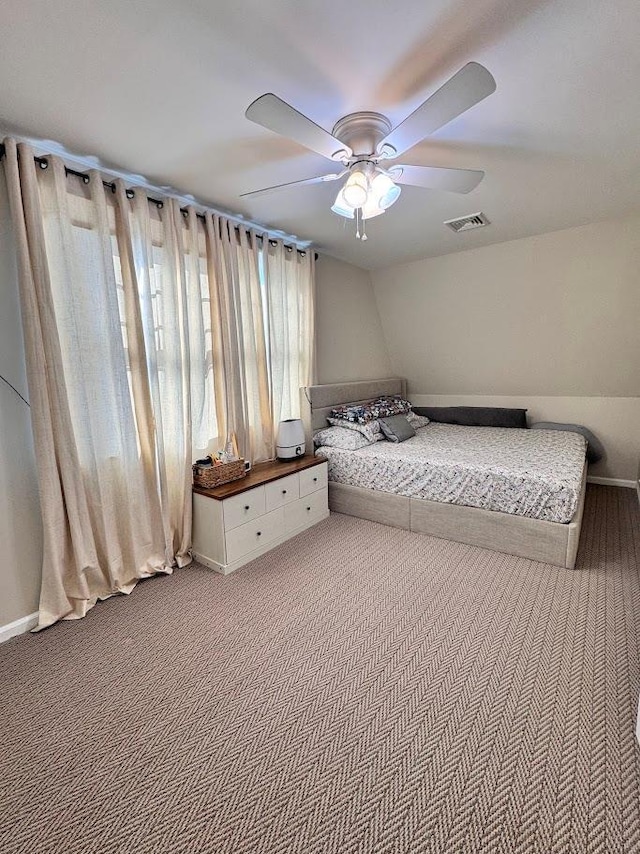 unfurnished bedroom featuring carpet floors, visible vents, and ceiling fan