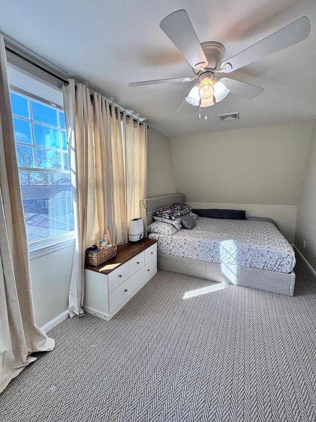 unfurnished bedroom with carpet floors, visible vents, baseboards, and a ceiling fan