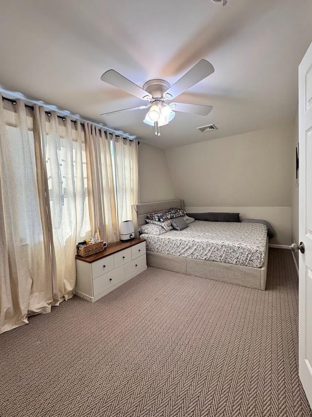 bedroom with carpet, ceiling fan, and visible vents