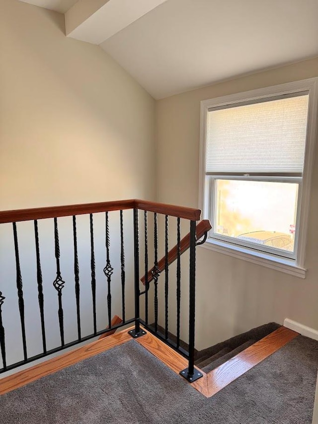 stairway featuring lofted ceiling