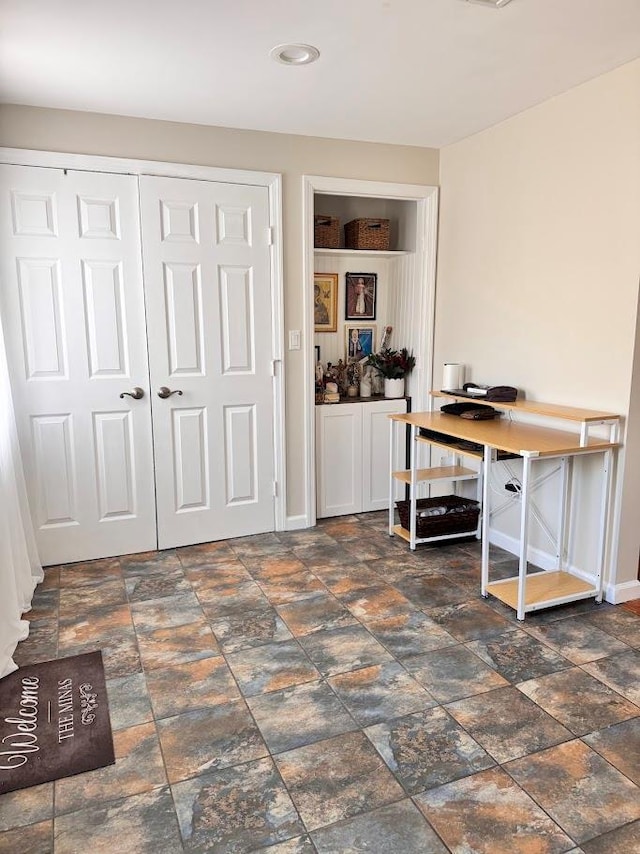 office area with stone finish floor and baseboards